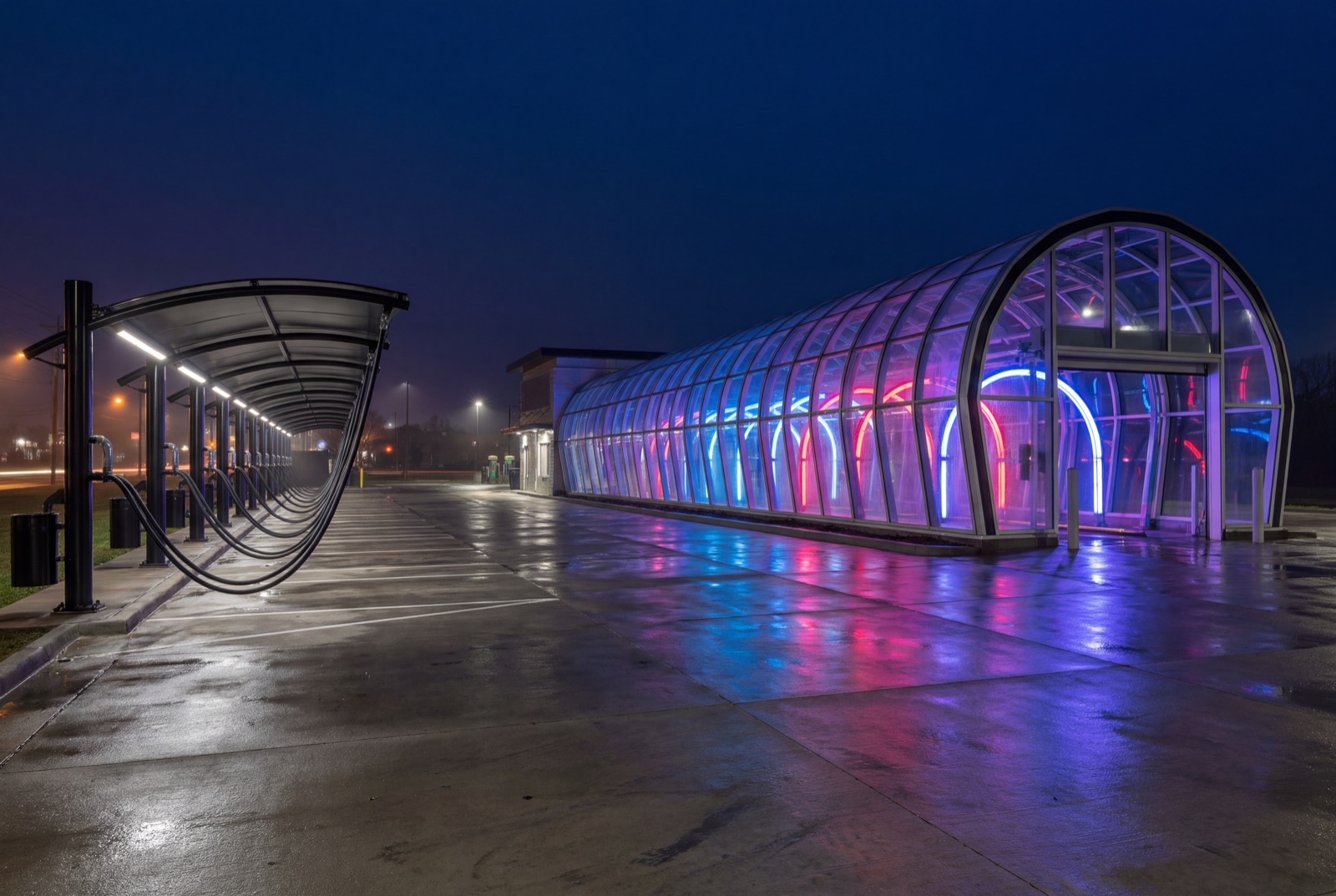 Modern express tunnel car wash glowing at night